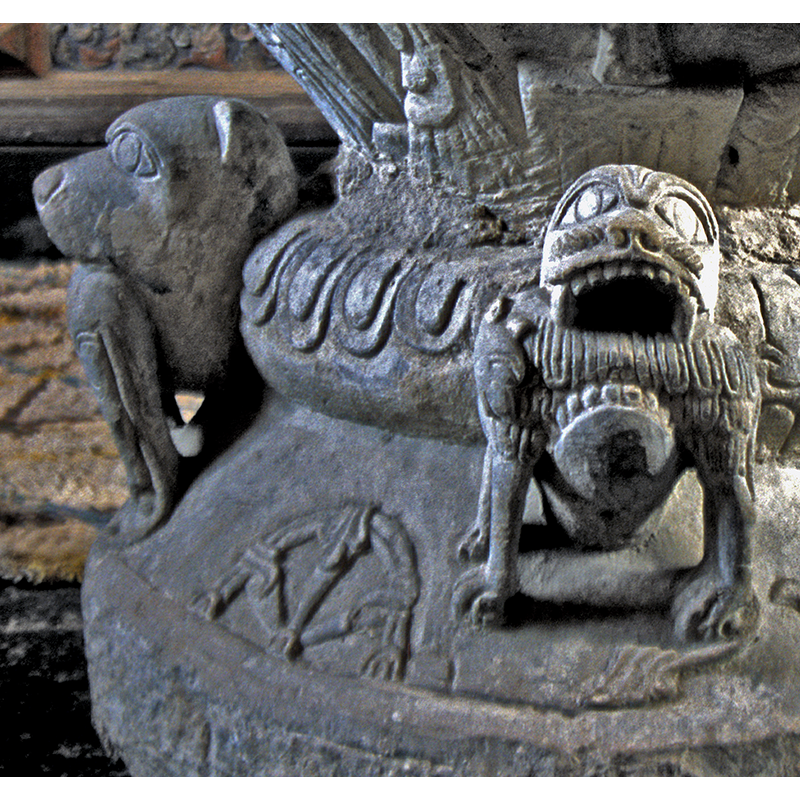 an interesting motif showing a foliated interlace is located between the two beast heads devouring prey