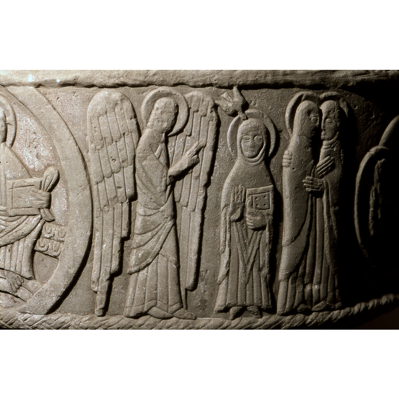 Annunciation to Mary: Gabriel stands to the left,in profile, facing right, haloed, with both wings displayed, right hand raised in benediction. To the Right is Mary, her left hand holding a book, the right hand at waist level with palm open; Mary wears a head covering, haloed with dove above her and open wings.