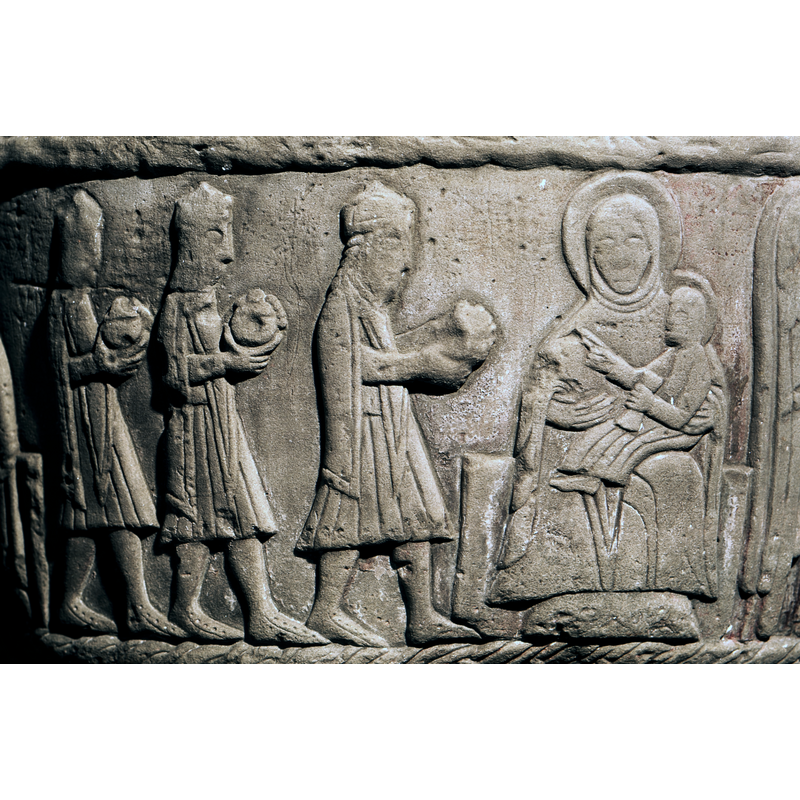 Adoration of the Magi: three crowned figures wearing short mantles and fancy footware carry gifts, walking towards the right, where the Madonna is enthroned with the Child on her lap; both haloed; the child holds a scroll of folded cloth in his left hand, the right pointing to the Magi
