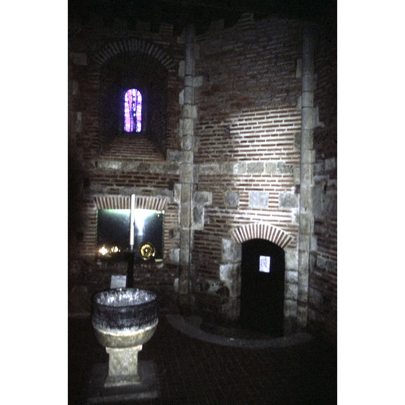 the metal font is now located in the centre of the baptistery, where the old sunken piscina would have been located