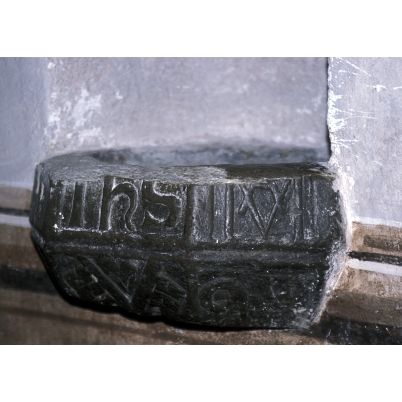the lower part remains of what may be construed as one of the symbols for the above, seen here in the top rightmost panel, to the right of the IHS monogram