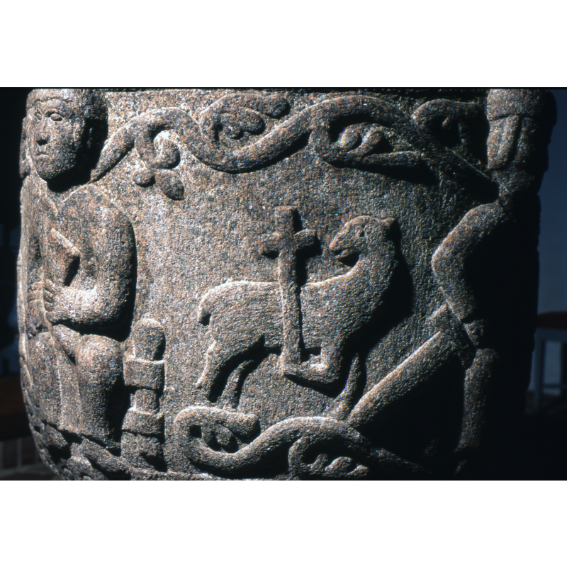 The lamb of God, Agnus Dei, body faces right and head turned to left. Front right leg holds up a cross. An acanthus vine encircles the upper and lower rim of the bowl.