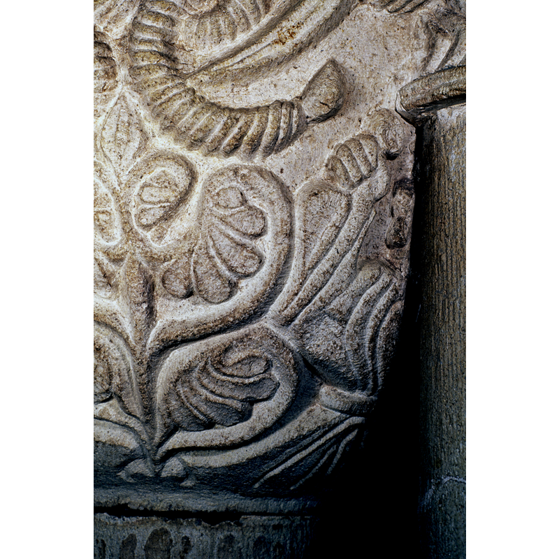 Arms raised; "orant"? -- towards the underbowl: the left half (cut off by the column)