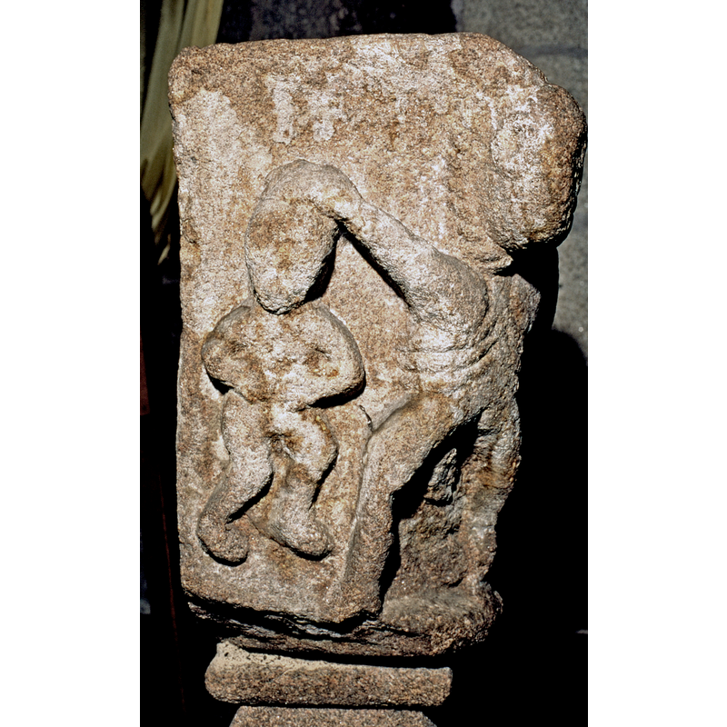 being held by the hair/head -- notice the rope around the taller figure's neck