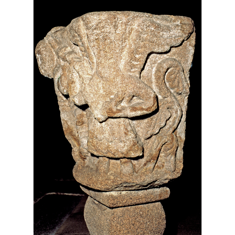 the angel, who has been defaced, holds the rope in both hands; the wings are open and clearly visible to the sides of the damaged head