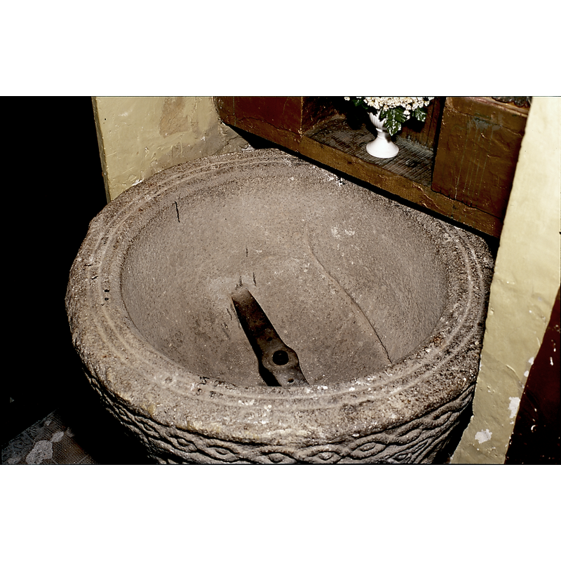 the metal contraption inside the basin is part of a modern mechanism that allows the font to rotate on its axis
