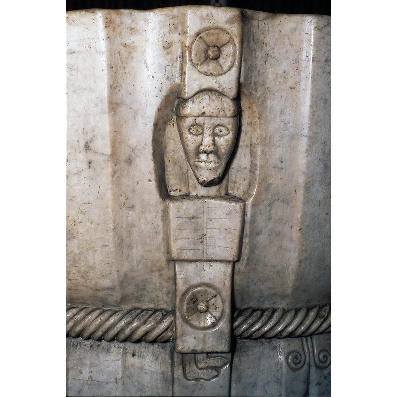 On the south side of the basin [NB: Ponsich identifies this figure as Christ]; the book is not really held by the figure but, rather, it makes up his chest