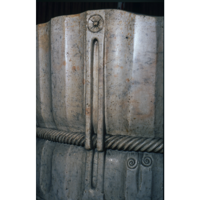 below the rope moulding: with scrolled tendrils; upside down?