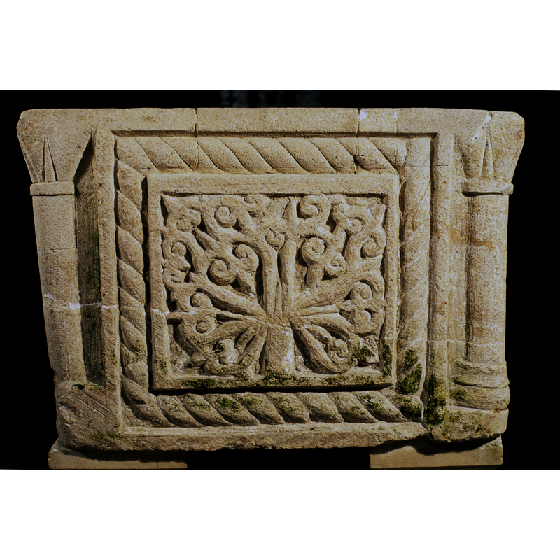 on the west side; the plant has the same fleur-de-lys like motifs at the outer ends seen on the north side -- notice the long through crack towards the lower end, and the stone-insert repair to the upper rim area