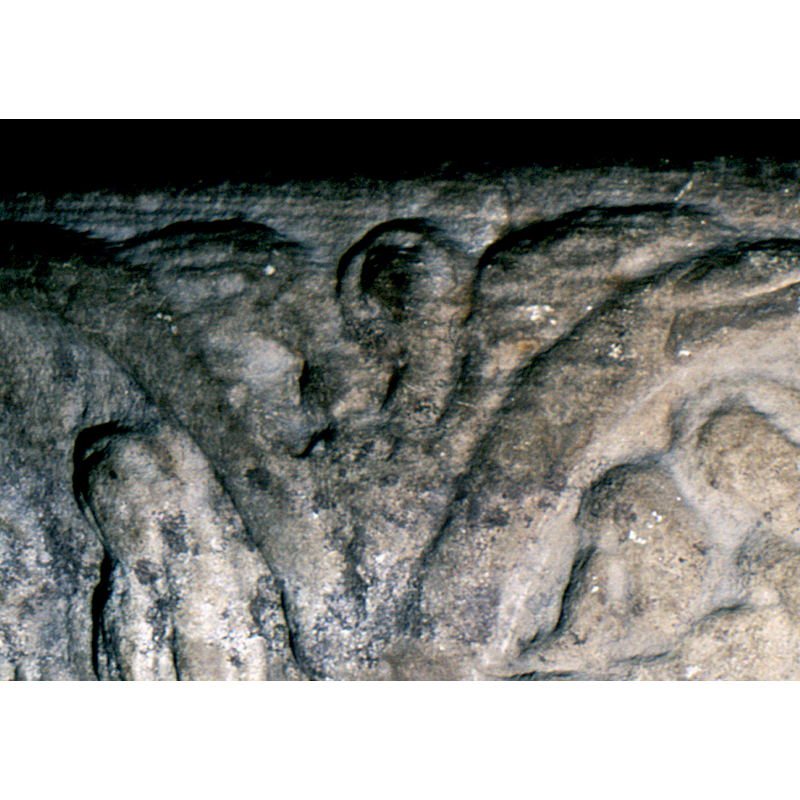 the elements that decorate the spandrels of the arcade are badly damaged and eroded, but some outlines are still discernible enough to make out their identities: this one a seraphim, with upper wings extended, lower wings folded