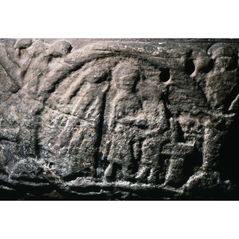 Presentation in the Temple. There are three figures, one to the left with long gown, long braids. The middle figure wears a tunic and holds the child who sits on an altar-like table. The middle figure is haloed.
