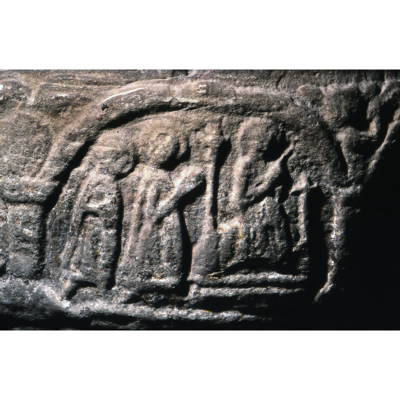 Three figures, two on the left, haloed and carrying or holding something in their hands - the right half of the composition has a throne, two bars, each side a cross, the left cross taller - seated figures, haloed and pointing with right arm diagonally upward.