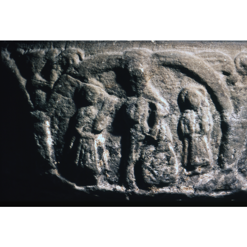 This scene is difficult to identify.three figures the one on the left is full frontal, wearing a tunic, right hand to the chest, the left holds an object - acanthus palm (angel?) The figure to the right, haloed, wears a short tunic - may be in a gesture of blessing? In the centre, the figure in the centre is much taller, right hand raised, left hand down holding a large object