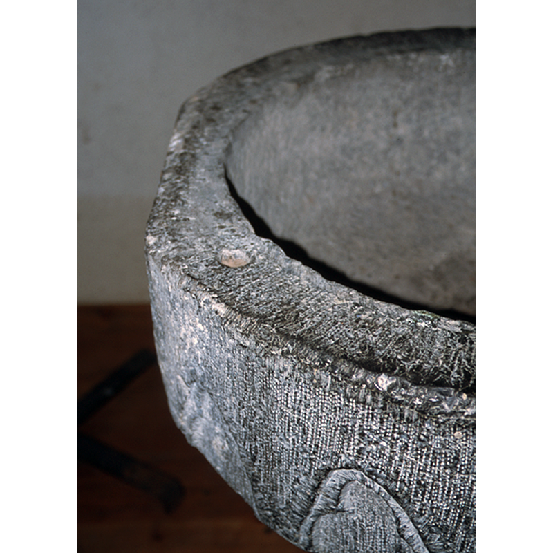 showing a)a plug in the rim for the lid hardware, and b)the irregular and later cut of the stone just behind the plug