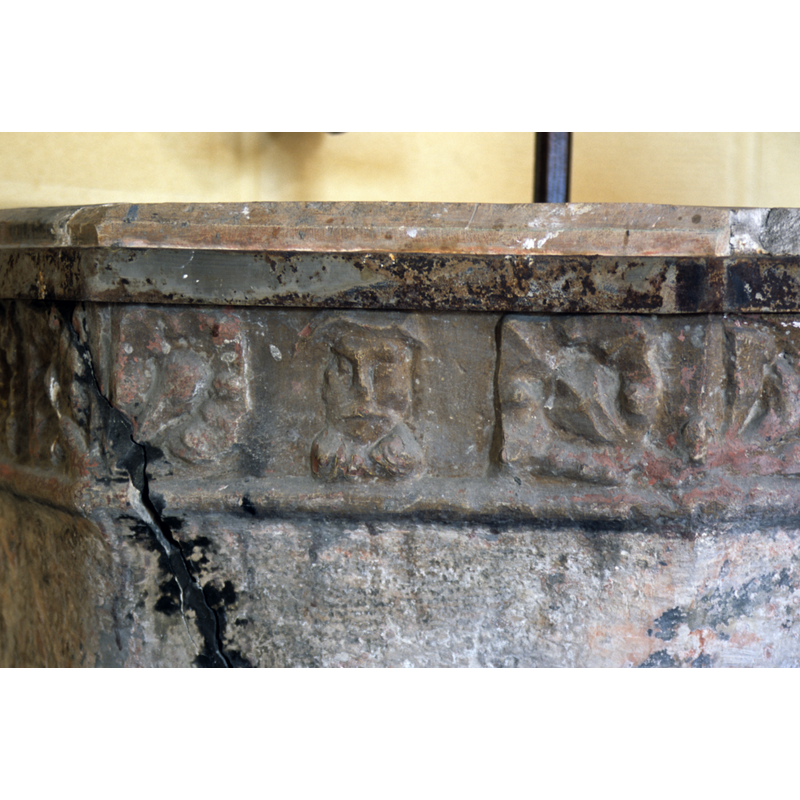 between two foliage motifs -- notice the repair to the large diagonal crack, and the reinforcing metal belt