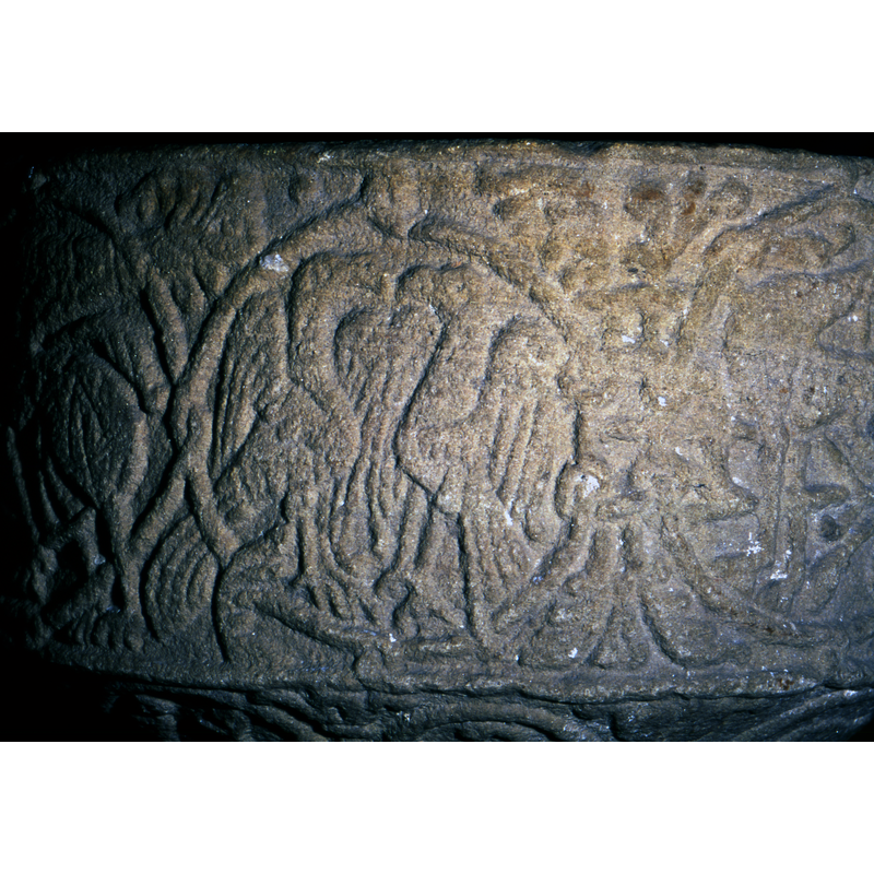 Two eagle like figures facing each other - mirror images - see reproductions of this type of motif on early or oriental textiles - seems to have influenced the design of this font.