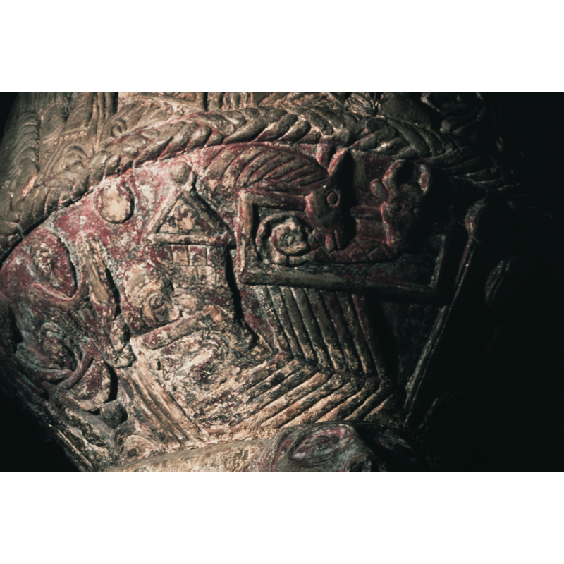 Nativity. To the left, a bed with Mary, in profile, the left hand holds the left side of her head, the right hand lies on her abdomen. Behind Mary, to the left, sun or moon (?) or star? Directly behiind Mary a tower with peaked roof and knob on top. Above Mary's bed a rectangular cradle, child is swaddled, haloed, crossed and head to the left, above the cradle to the left the ox and mule. From the cradle rays project onto the Virgin's bed. After the bed, a star (round) with long rays (could be bedpost - but not connected to bed and very similar to the next representation of a star with rays). To the right of this is Joseph in profile, facing Mary, head resting on his right hand, and above him a cloud with an angel who has its head upside down.