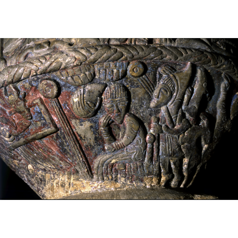 Joseph seated in a pensive/dormant stance at the centre of the image, between tyhe Nativity (left) and the annunciation to the shepherds (right); an upside-down head leans to his right ear