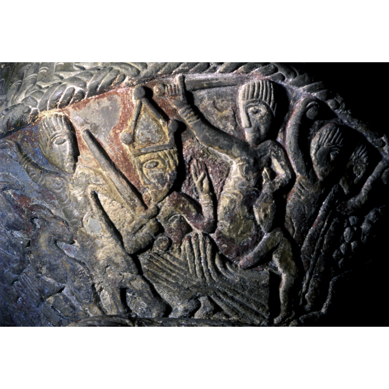 Massacre of the Innocent. To the left, a figure, points up and left. The next figure to the right, sitting, full frontal, head turned toward the left, is crowned, the right hand holds a sword and the left raised with palm outward and thumb in.To the left of Herod, a soldier, holds a raised right hand with sword and the left holds an infant by the hair -- at the far right the two figures are part of the next scene: the martyrdom of Stephen