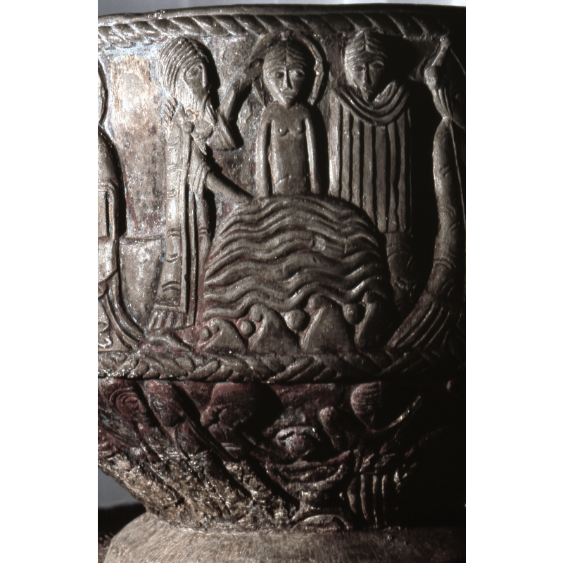 Baptism of Christ. Christ immersed in water up to his waist, haloed, full frontal. To the left in profile, St.John dressed as a priest, one hand in the water, the other hand on Christ's head. To the right a figure, full frontal holds out a large towel.