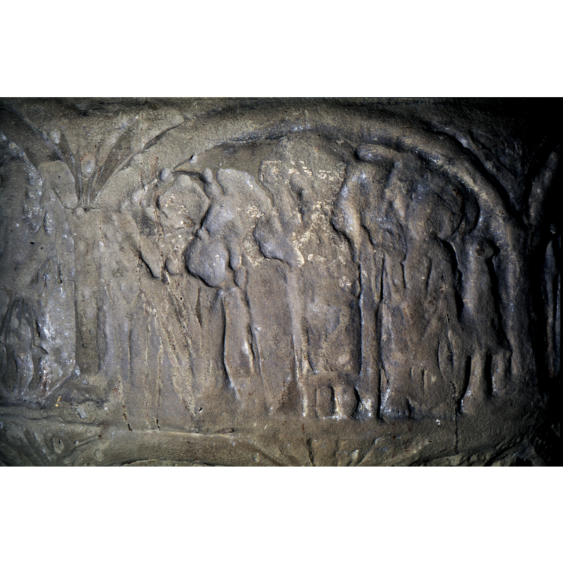 In this scene there are four figures, full frontal, all haloed, all dressed in long complex, rich garments. The two figures on the left hold a staff with a knob. The figure on the extreme right is seated/enthroned. Roosval (1918) suggests it is the interrogation of the Magi by Herod, but the seated figure is haloed, therefore not Herod. Is it the Madonna and Child? Christ enthroned?