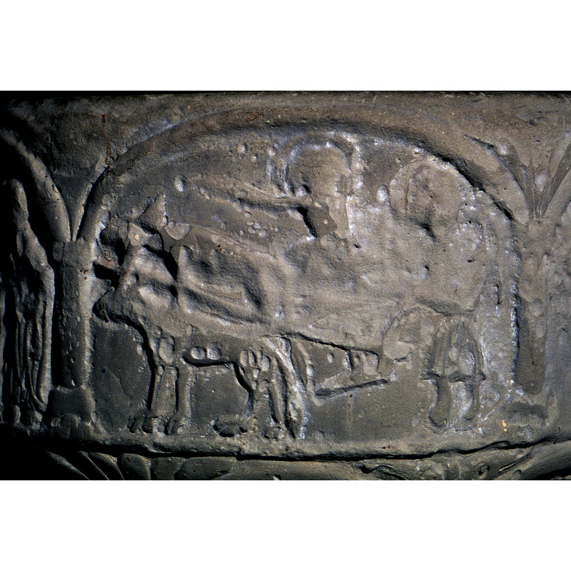 On the left half of the composition, a pair of four legged animals, tied together at shoulders - pulled by one bridle. It seems to pull a plow. To the right is a figure, standing, haloed, wearing a short-knee length garment, holds plough handle and one hand goes back holding a whip? There is another figure above the plough. The upper body is haloed and remnants of arm pointing to the left - toward the oxen and straight ahead. (Josiah was called by the lord, dropped the plough and called to lead the army?).