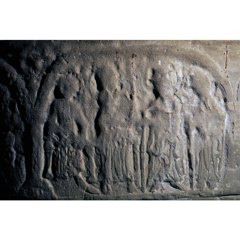 Four figures are in the scene. The figure on the far left side of the composition is enthroned. The second is kneeling or standing with a staff. The two figures to the right are standing, carrying staffs. They might have been haloed. All are robed. The figure on the throne wears a pair of shoes. The others appear to be barefoot.