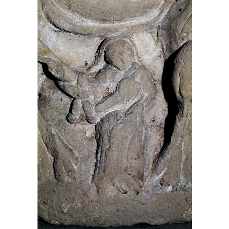 the pointing hand appears to be caught in the intertwined tail of the animal on the left; the left arm appears to be holding her garment