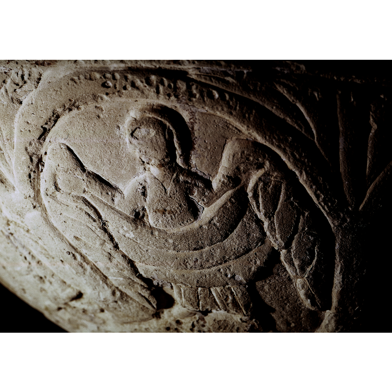 A figure, a woman, full frontal, head turned to the left - looking toward the leftl she is holding a large cloth in front of her; could this be an angel? the wings may be the large folded cloth on either side? Not according to the drawing in Roosval (1918)