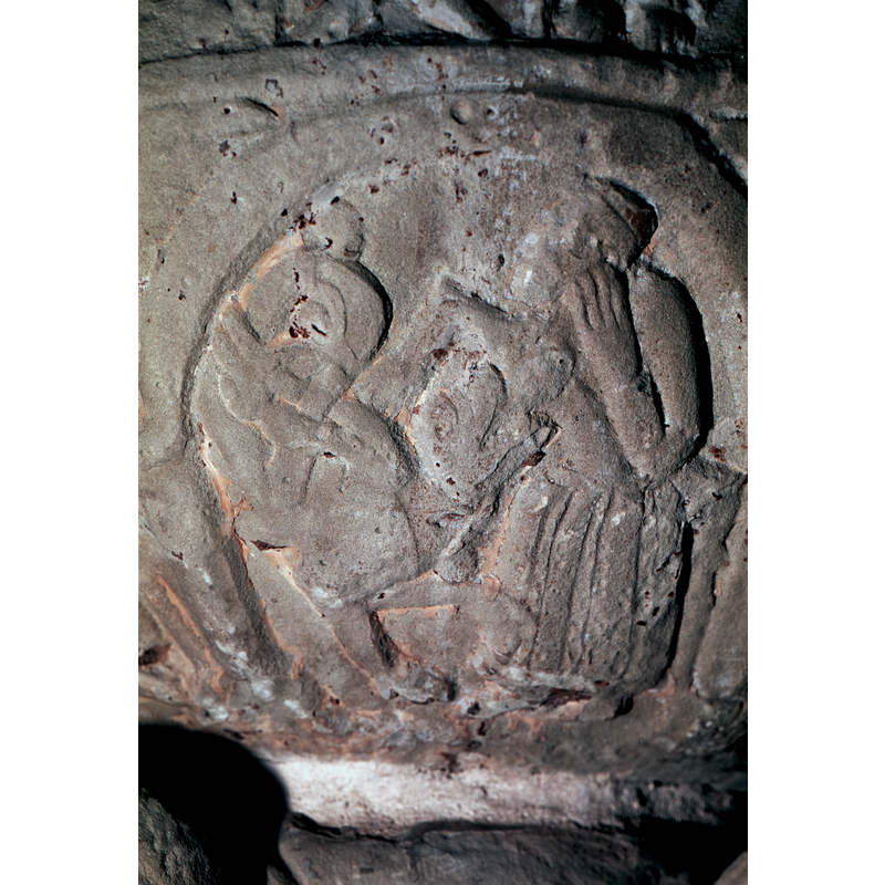 Figure of Luxuria to the right, naked to the waist and wearing a long skirt; is s/he seated or has s/he a sword to the right? The left arm is bent at the elbow, hand extended, on which rests his head; the right arm projects forward and is bent down at 40* angle over the body of an animal. The figure appears to be a woman with a dragon/serpent or demon at her breast. Roosval (1918) suggests the Labours of Hercules for scenes 2-3-4 of the underbowl