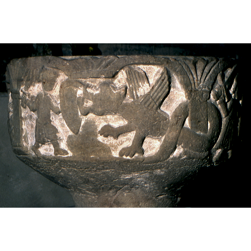 the carver has been creative in the rendition of the supporting columns; in one scene, the warrior fighting a dragon, there is no supporting column in the centre, and the tail of the dragon wraps around the column behind; in the Baptism scene the columns are there, but are seen only partially behind the characters and the action; the same occurs in the centaur fighting scene