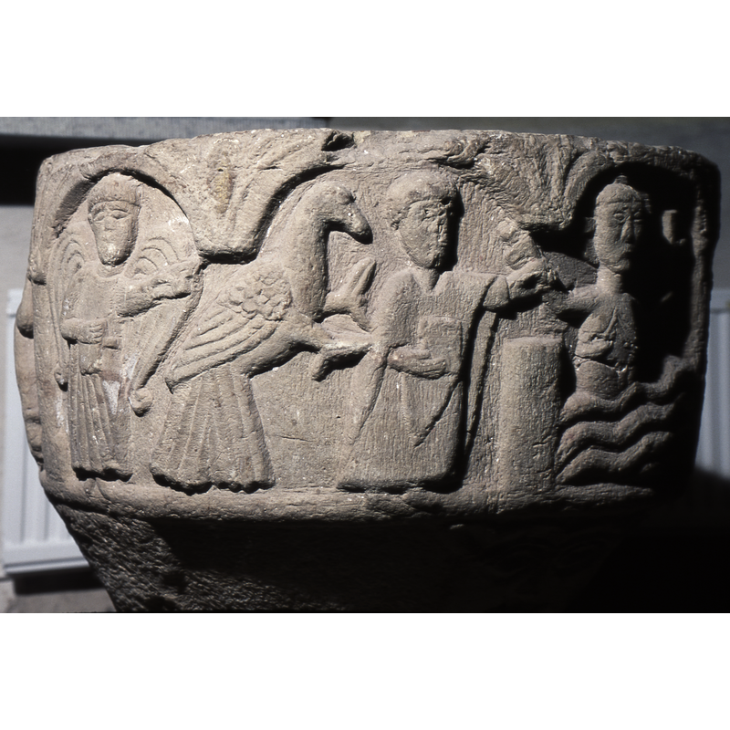 Baptism of Christ; three figures present: on the left is an angel pointing right to an enormous bird (dove?); to the right of the bird is John the Baptist holding a book in his right hand while his left hand holds the wrist of the right hand of Christ; the latter's lower body is immersed in water; he holds a processional cross in his left hand and wears a cruciferous halo