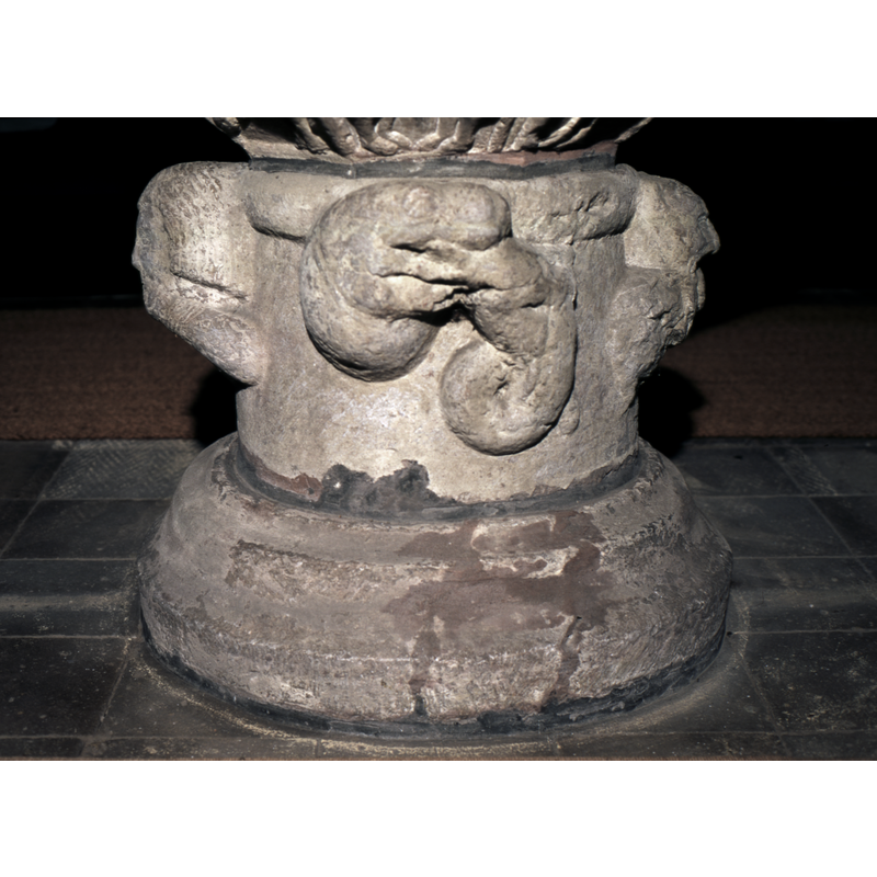 Under the nativity  - a snake like head eating another beast.