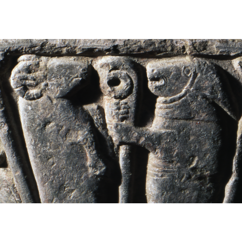 To the left - two animals. One on the left is a goat standing on hind legs (a ram) - and the one on the right is an animal, looks like a dog, dressed in shepherds clothing with bishop's staff.