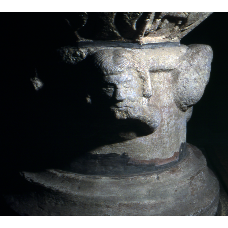 a Man's head holding his beard or mustache - this is to the left of the previous.
