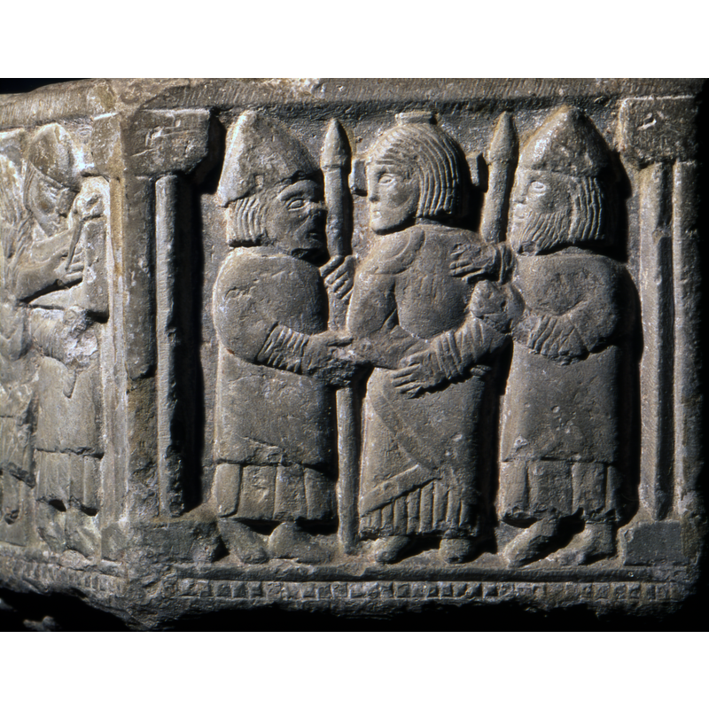 Jesus being Captured. In one side, there are three figures - in the centre, Jesus, hands tied, the head turned to the left side, no halo but has a cross - to each side a soldier in profile, facing him, they wear helmets, carry lances and hold Jesus by the arms. One is bearded the other is not.