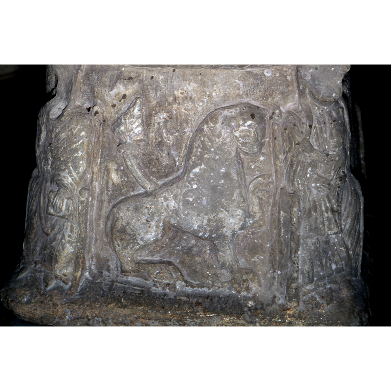 To the right of the Bishop- a lion, tail curled and up and left paw raised. Facing right.