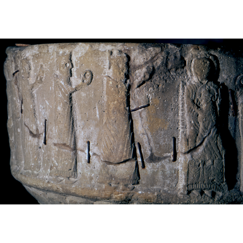The magi are in profile, holding gifts, manteled and robed, crowned, walk left to right, To the right is a star and the M,adonna and Child. The Madonna is full frontal, haloed and sitting on a throne. The child is in profile to the right side of her - he is haloed and raises hand in benediction. The lower part of Christ is inside her mantle! -- the cracked stone and the old rusty staples used in the repair are clearly visible here