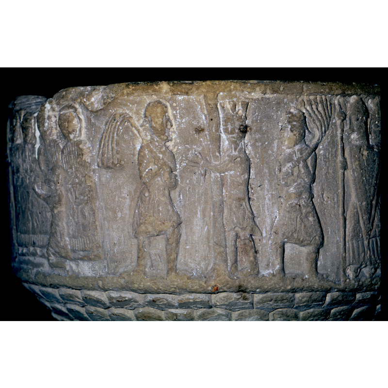 Flagellation. Christ in the centre, tied to a pole, and crowed, face full front, bearded, body in profile. To the right and the left two soldiers with whips - cat tails- To the right of these 3 figures, dressed in medieval armour - holding long pointed shields, lances, concical helmets with nose protection. They also wear swords.