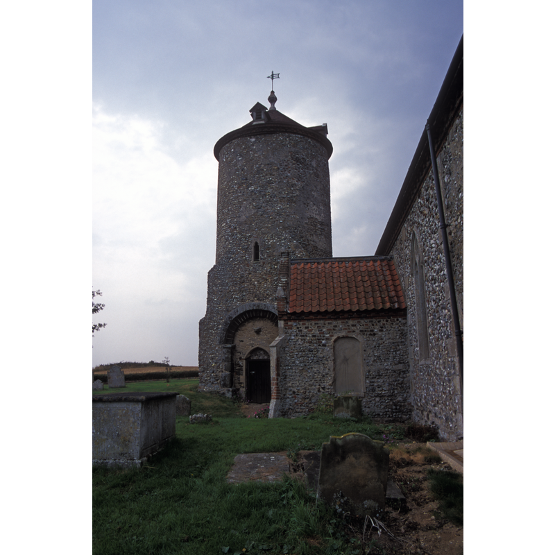 showing the east side of the old detached tower and the south porch of the later church