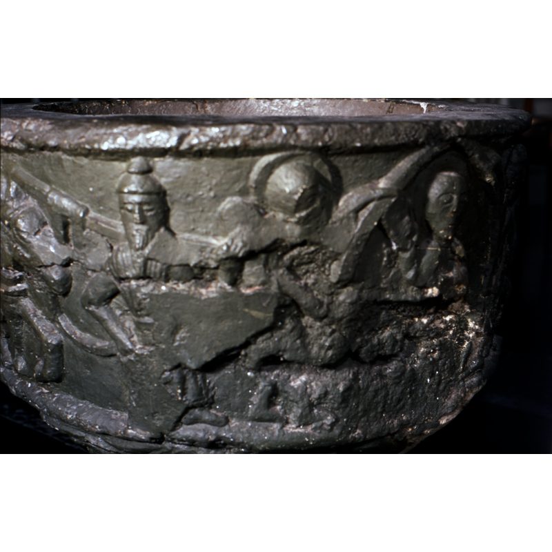 on the south side of the basin -- showing part of the Flight to Egypt scene on the left side of the image -- a haloed angel is partially discernible in the centre of the image here, one hand holding the top of the mandorla, the rest of the scene badly damaged; a haloed Christ inside the mandorla has his right hand raised in benediction, but the lower part of the basin here is also badly damamged and most of the scluptural detail has been lost