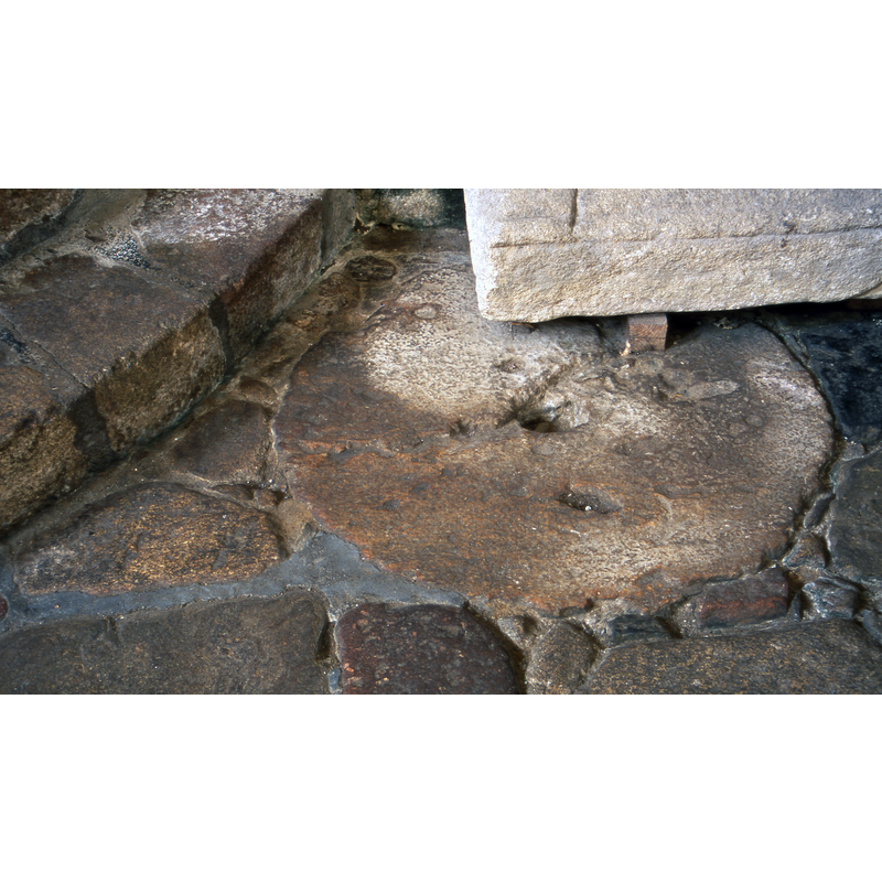 the plinth (?) of the ancient font remains in place inside the church, at the west end, south side