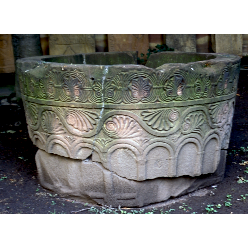 the columns show no bases but there are fragments of a roll moulding cutting horizontally across the lower end of the columns of the arcade