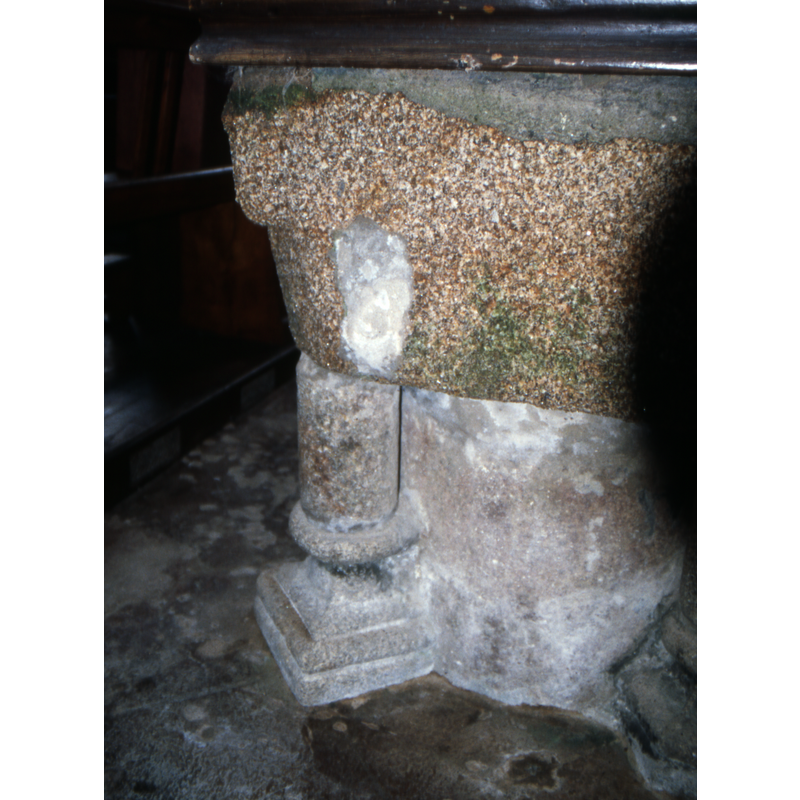 one of the four outer constructional columns of the base; they are not identical and they are said to be of a later date than the basin [cf. FontNotes]