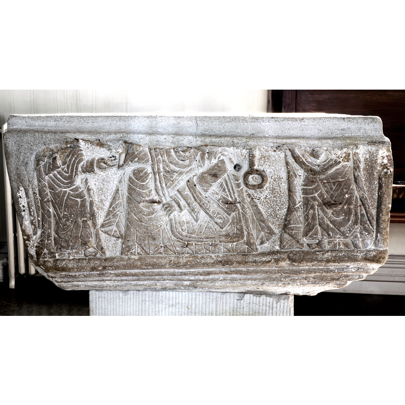 Sonne de Torrens (BSI) suggests this may be a 'Traditio legis' scene: Matthew 16:19, "I will give to thee the keys of the kingdom of heaven.": Peter [right] receives keys, Paul [left] a book/scroll