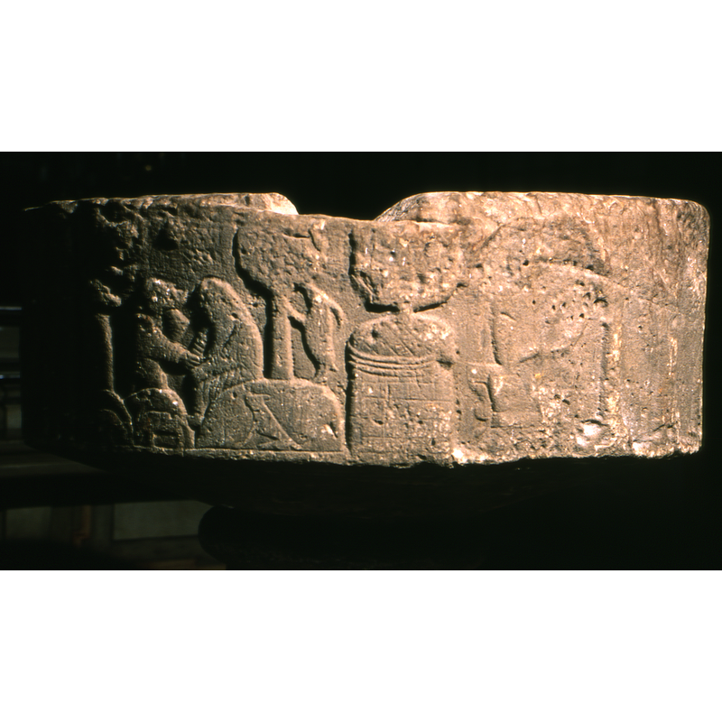 showing the Annunciation to the Shepherds on the left,and the Madonna and Child as part of the Adoration of the Magi scene on the right -- the cut in the stone of the upper rim may have been related to an anchoring for an old cover