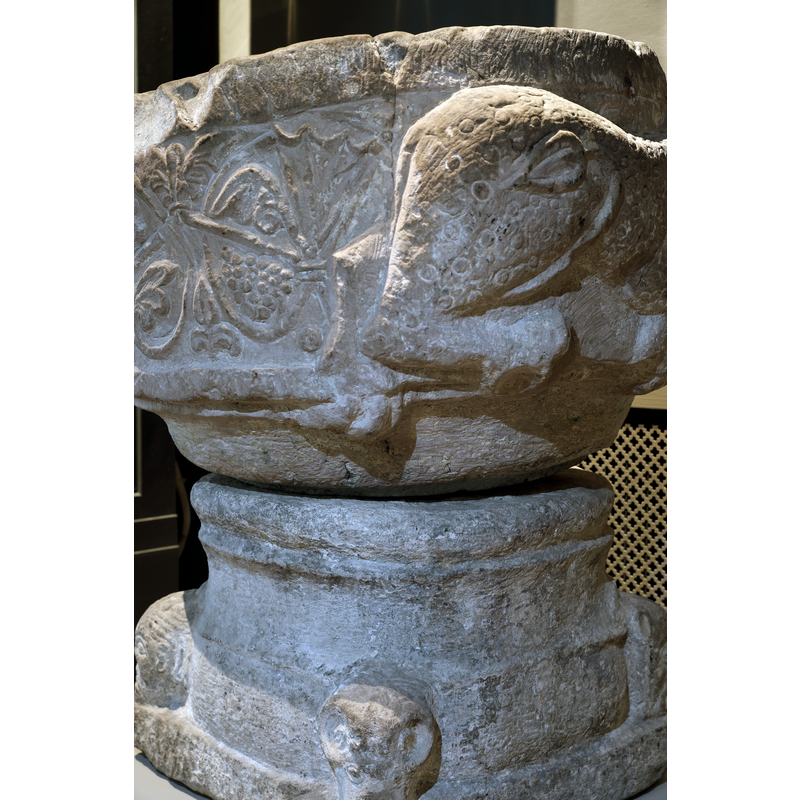 most of the bodies are missing now but the position of the remaining rear ends suggest they were facing lions on the now missing side of the basin, as they appear on other fonts like Oxie and its cognates
